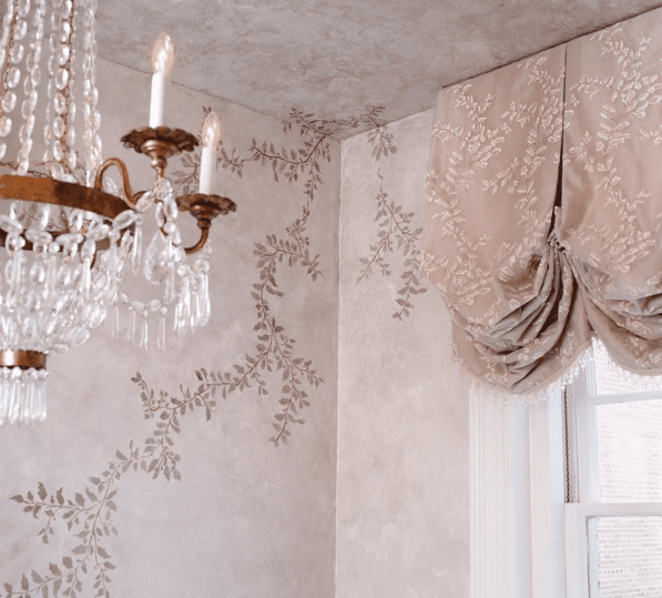 Elegant chandelier and ornate wallpaper
