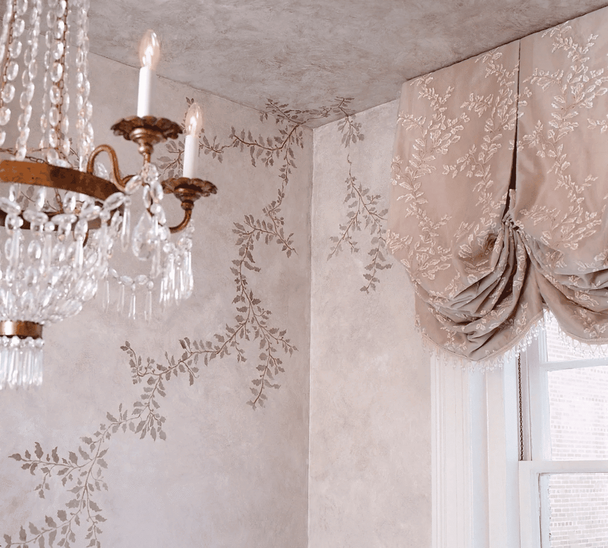 Elegant chandelier and ornate wallpaper