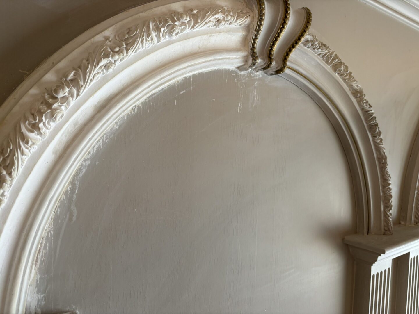 Ornate plaster arch molding with floral details