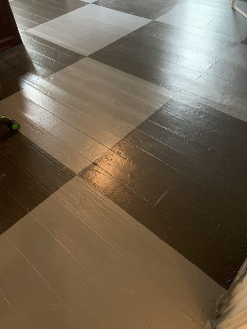 Gray and black checkerboard painted wooden floor