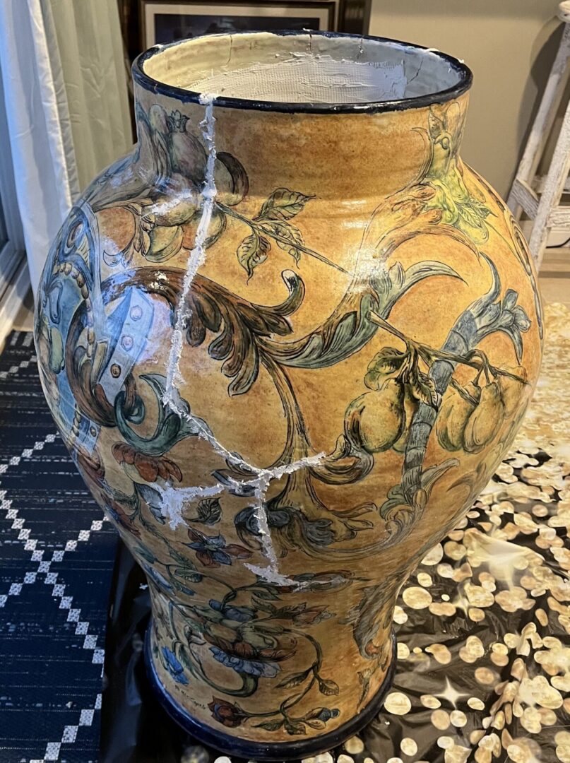 Large cracked yellow ceramic vase with floral design